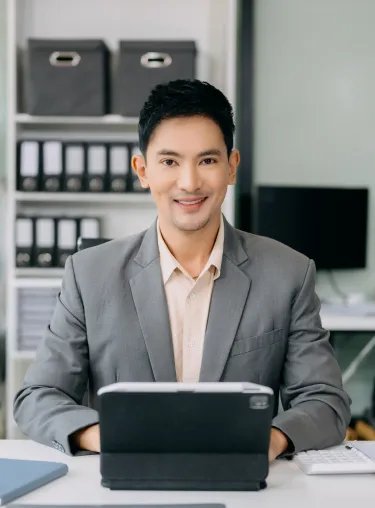 Professional using the InLife Benefits HR Portal on a tablet in a modern office for employee benefits and workplace management